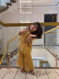 Girl posing in mustard organza kurta palazzo set