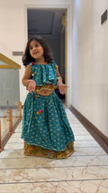 Girl in teal pom-pom ruffle garba lehenga set
