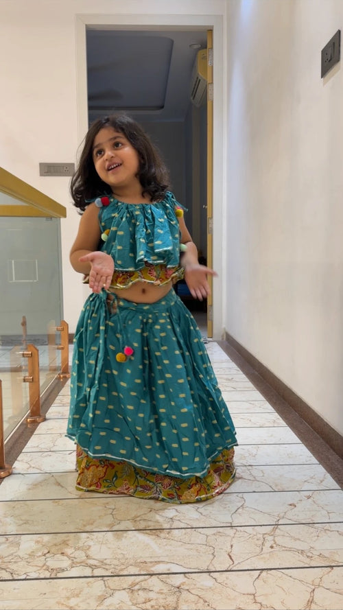 Girl in teal pom-pom ruffle garba lehenga set